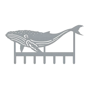 A detailed steel key rack depicting a humpback whale with intricate cutouts. The whale design is sleek and modern, featuring seven hooks for keys.